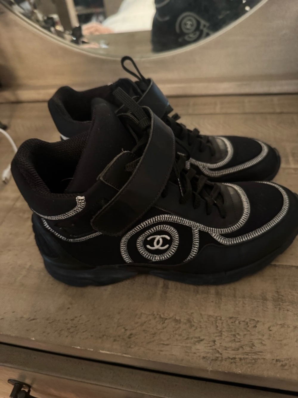 CHANEL Black High-Top Sneakers with White Trim Stitching